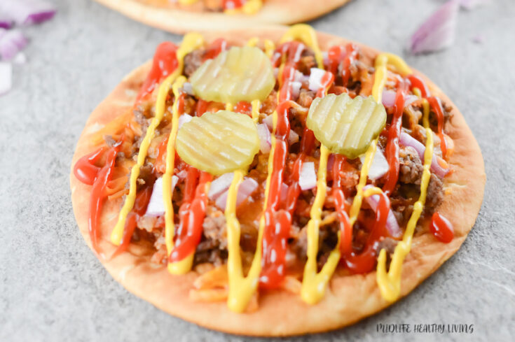 This featured image shows a single bacon cheeseburger flatbread pizza ready to eat!