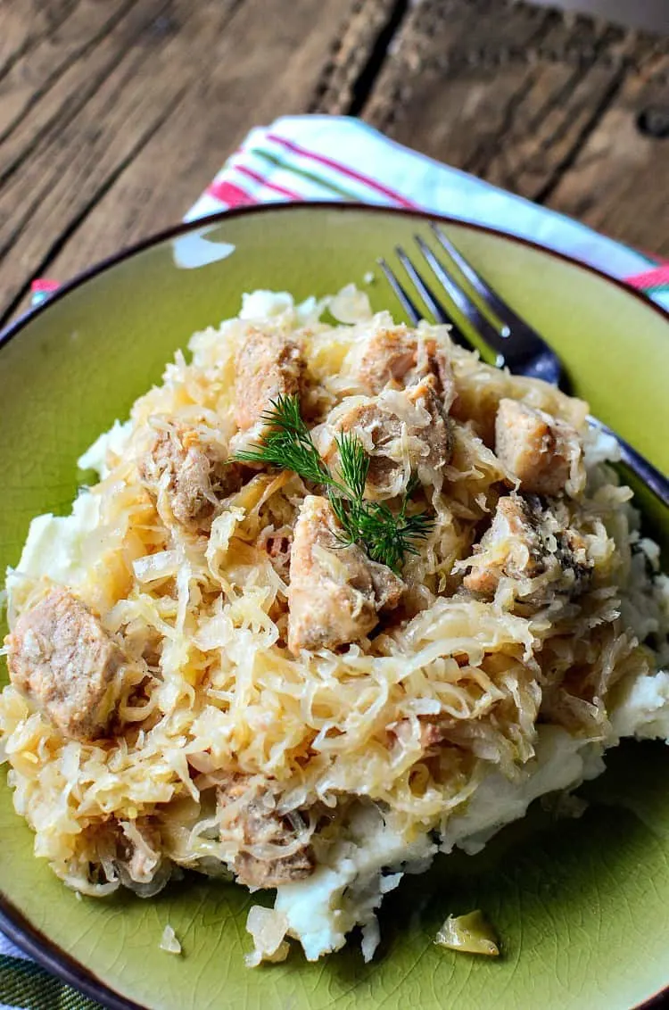 Featured image showing the finished crock pot pork and sauerkraut ready to eat.