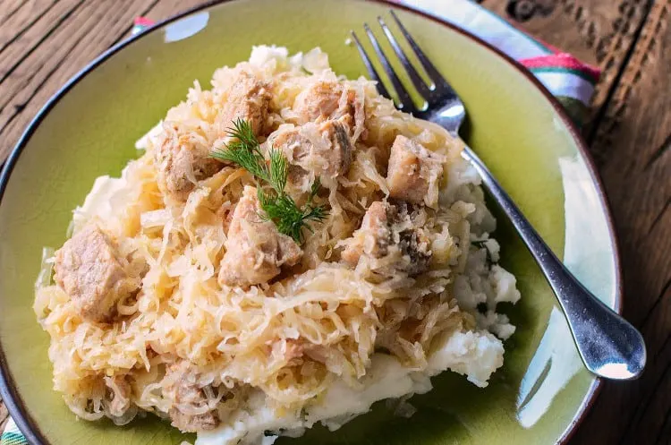 Featured image showing the finished crock pot pork and sauerkraut ready to eat.