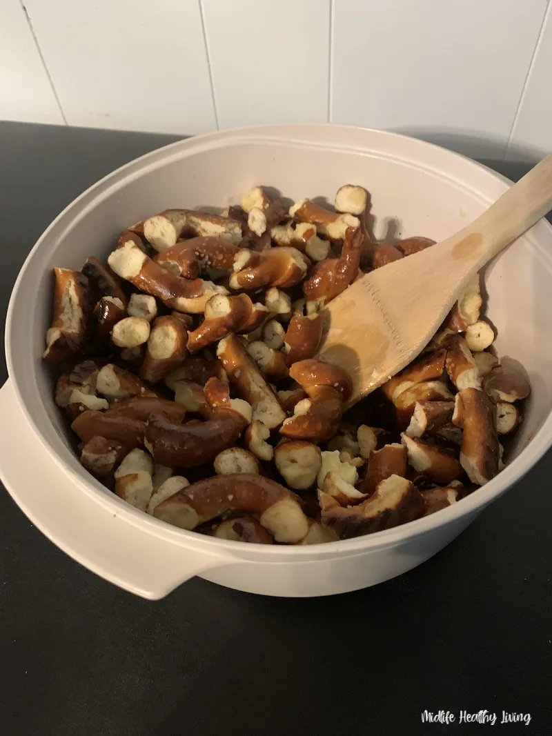 butter melted pretzels being stirred with wooden spoon