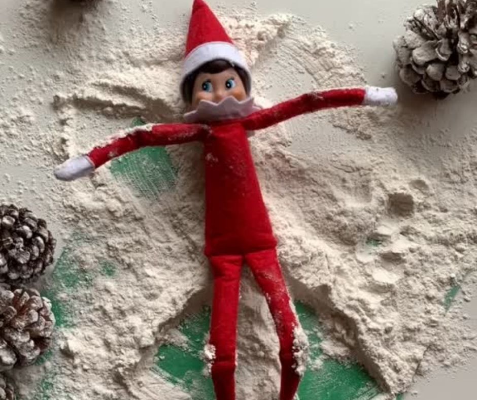 elf on the shelf making snow angels on flour