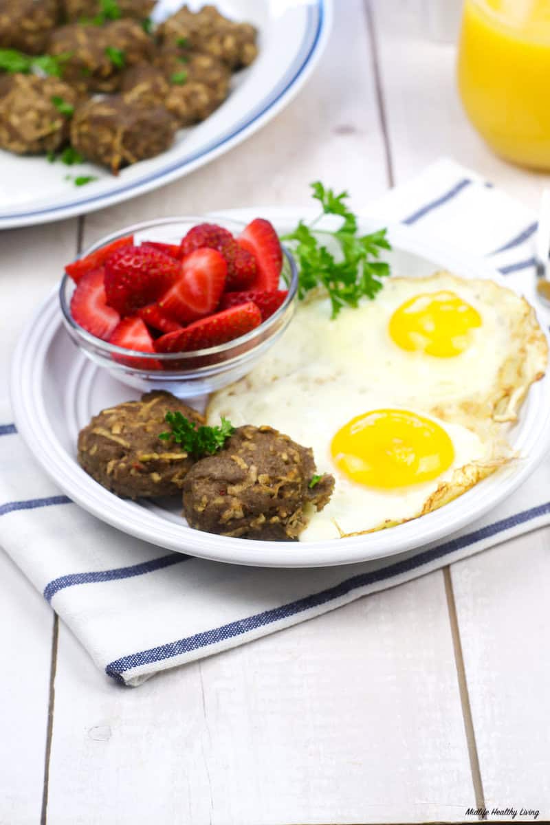 full breakfast of apple cinnamon sausage patty eggs, and berries. 