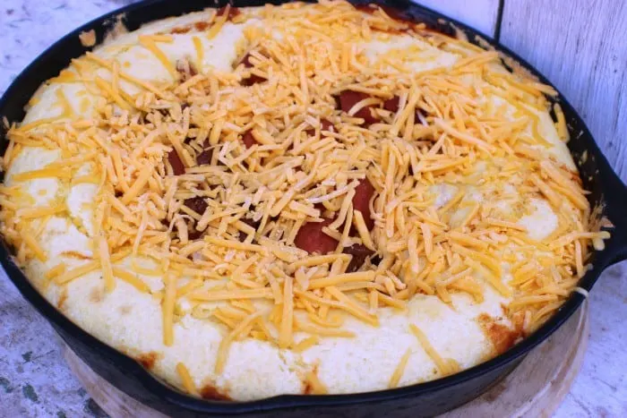 spicy chili dog casserole topped with cheese