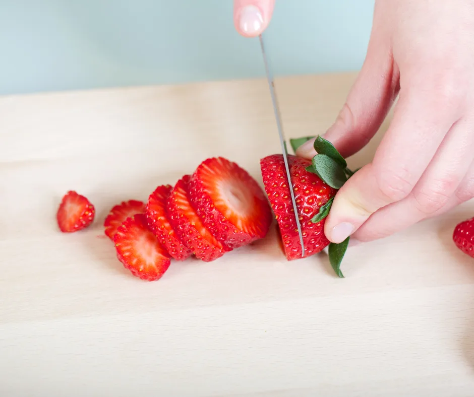 strawberries being sliced