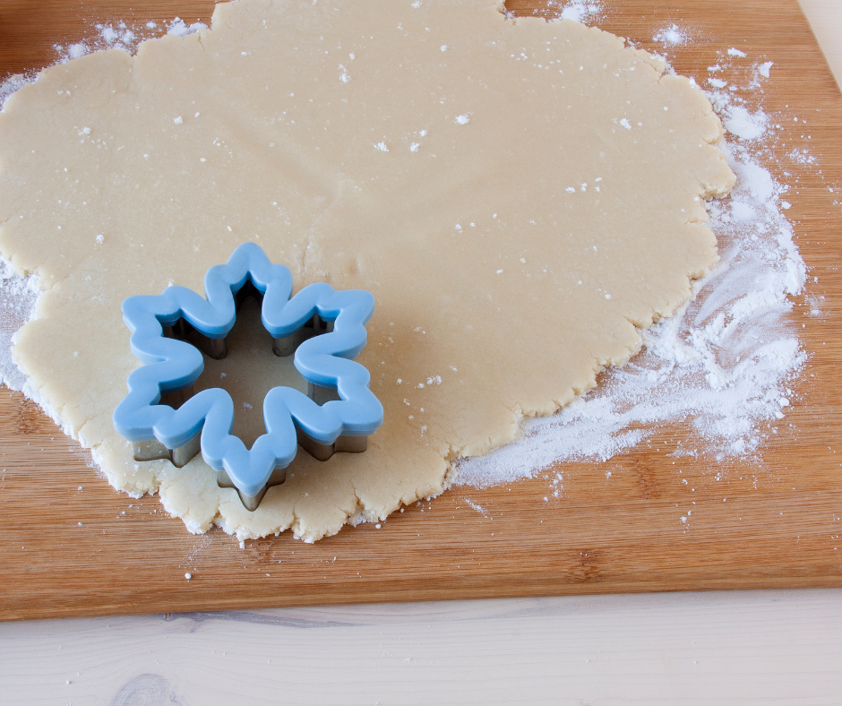 cookies being cut with cookie cutters. 