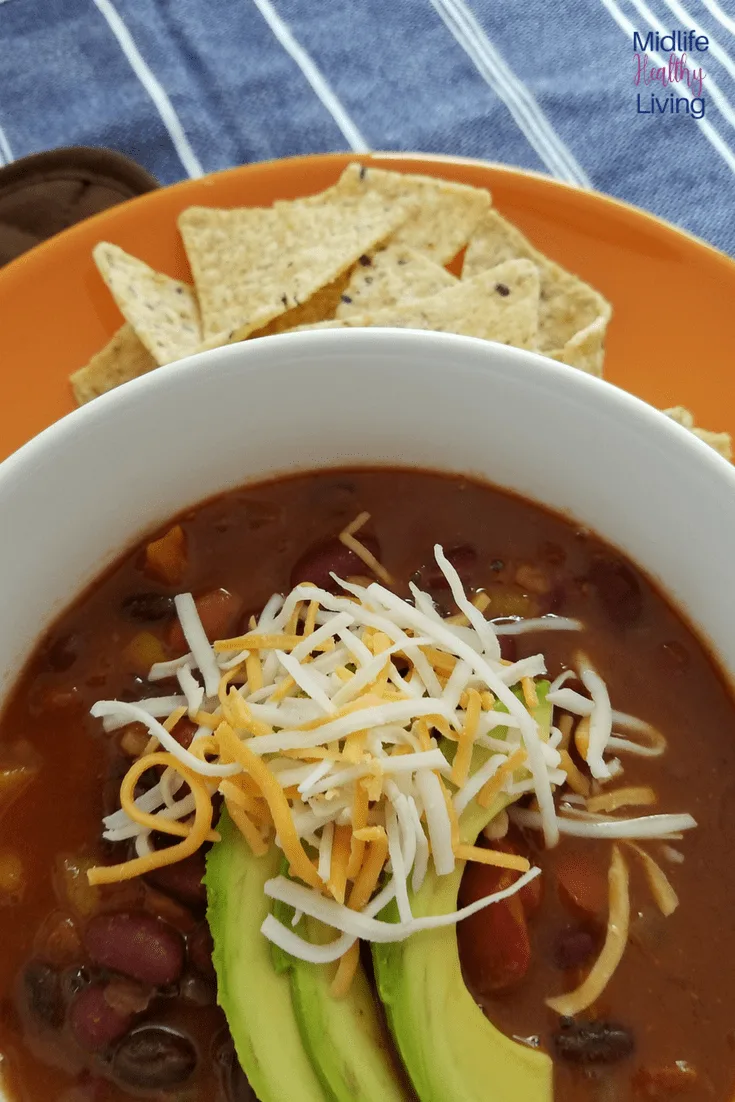 Chili garnished with cheese and avocado 