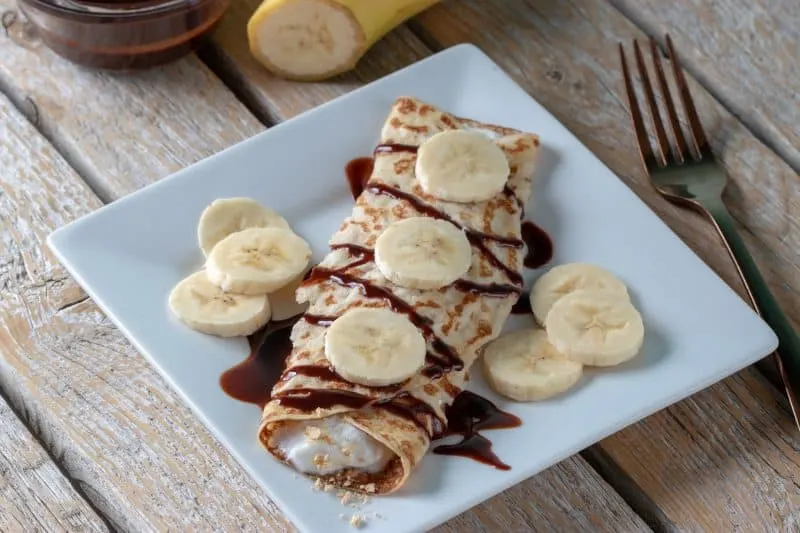 Weight Watchers chocolate banana crepes displayred on a white square plate