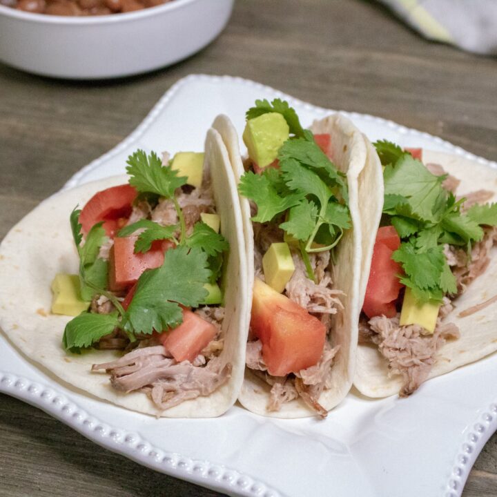 Need a quick and easy weeknight meal that can feed a crowd? These slow cooker pork tacos are a great family dinner recipe. The Crockpot does all the hard work, taco night has never tasted so good! 