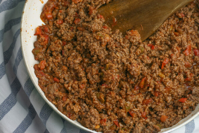 Cooking ground beef.