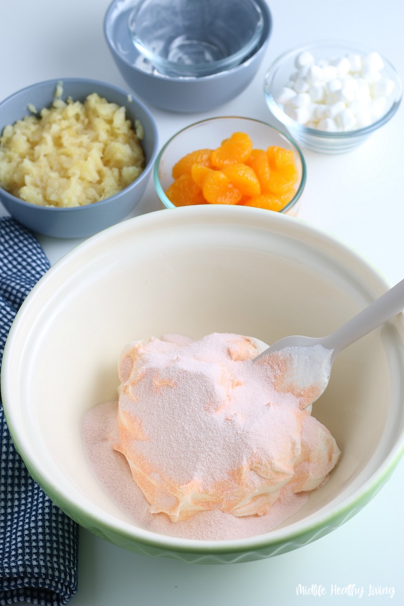 Beginning of the process for making orange fluff jello salad. 