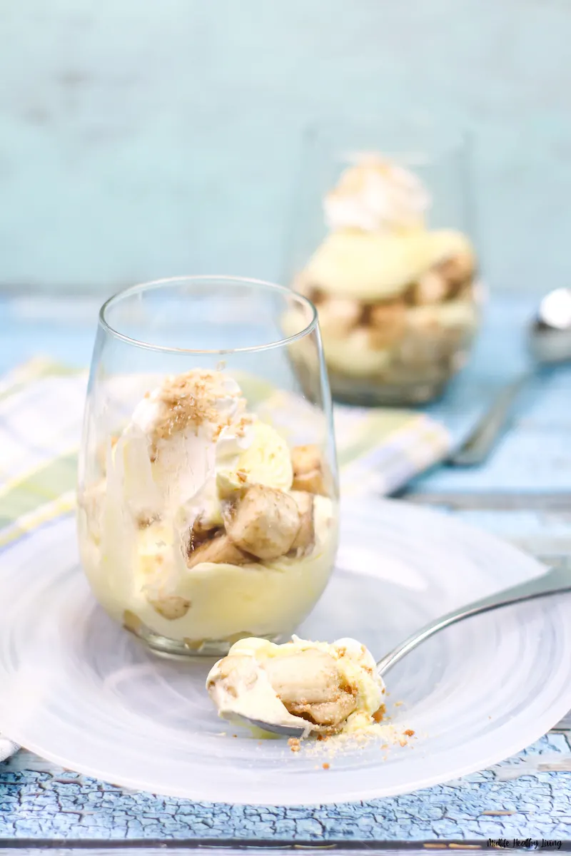 a banana pudding ready to be enjoyed with a spoonful ready to eat