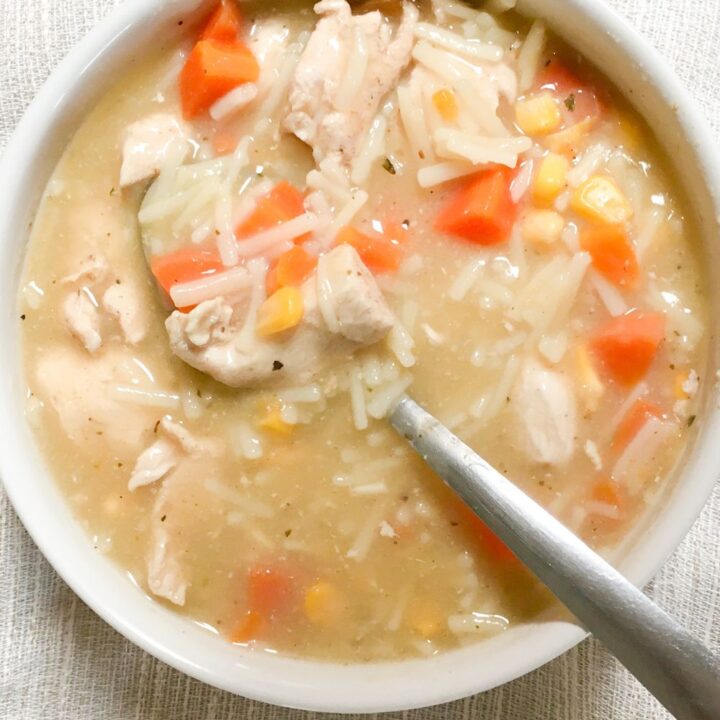 Homemade Chicken Noodle Soup in a white bowl from above