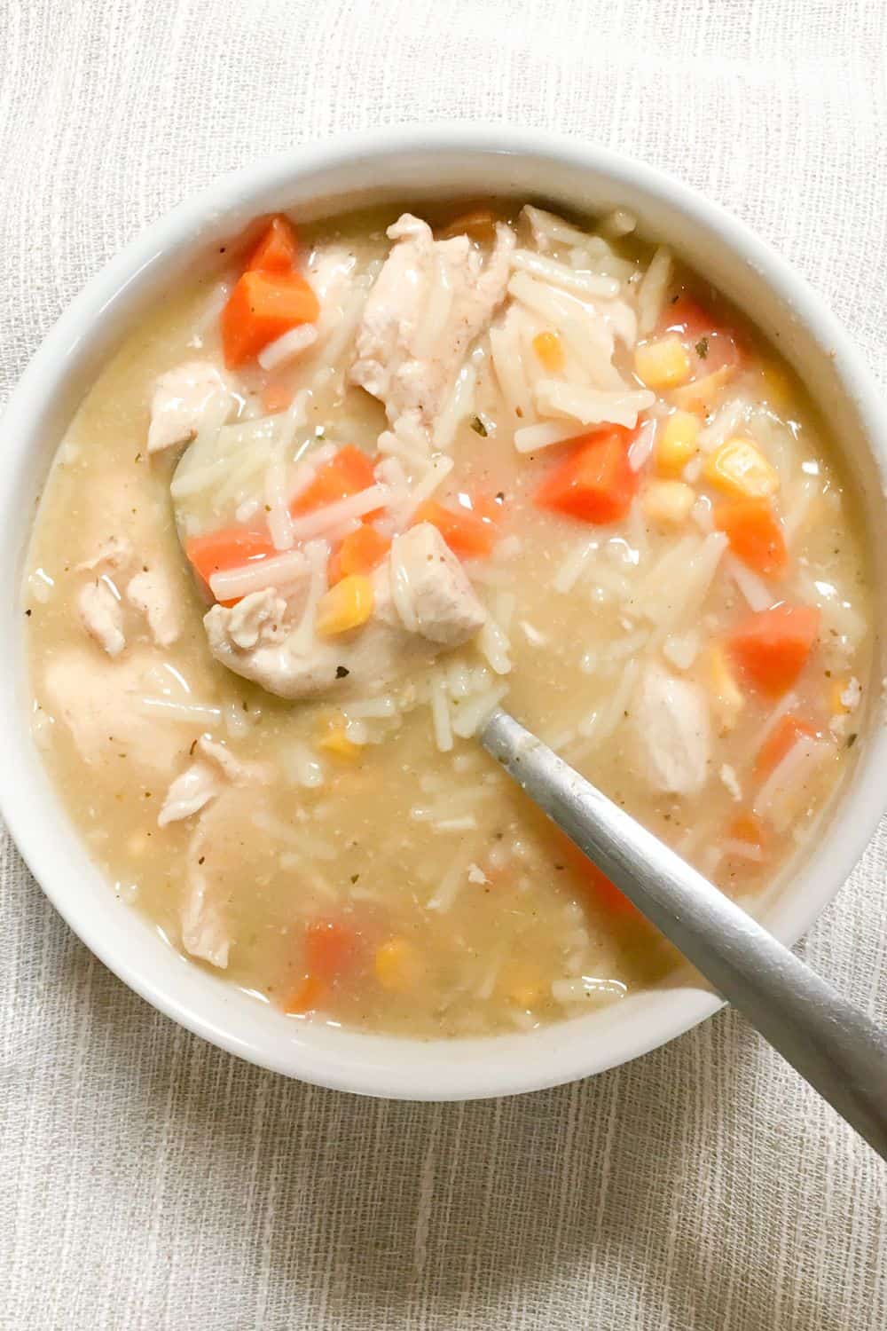 Homemade Chicken Noodle Soup in a white bowl from above