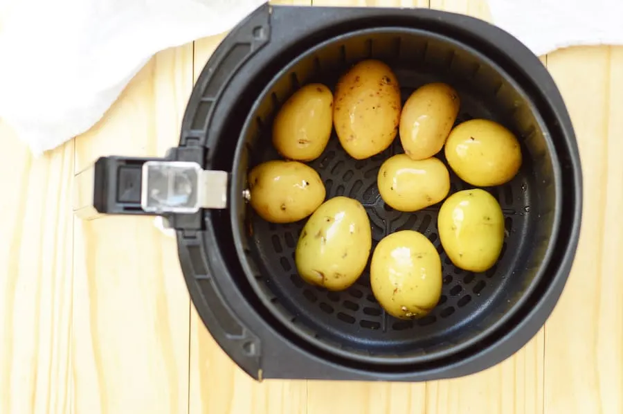 A view into the air fryer as the potatoes are cooking.