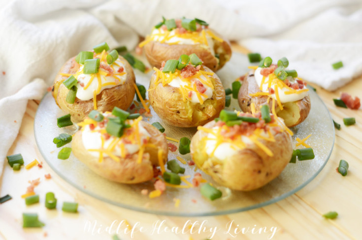 Featured image showing the finished and topped air fryer loaded baked potatoes.