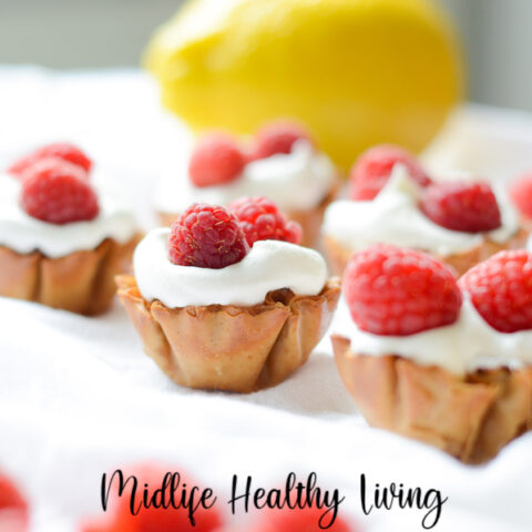 Featured image shows the finished lemon cheesecake bites with raspberries on top