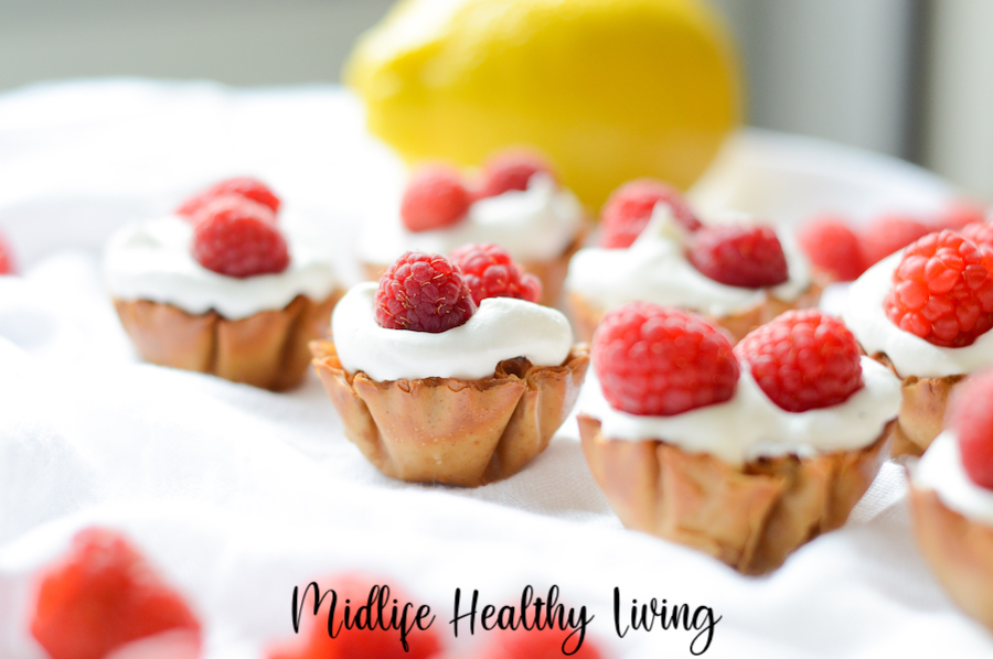 Featured image shows the finished lemon cheesecake bites with raspberries on top