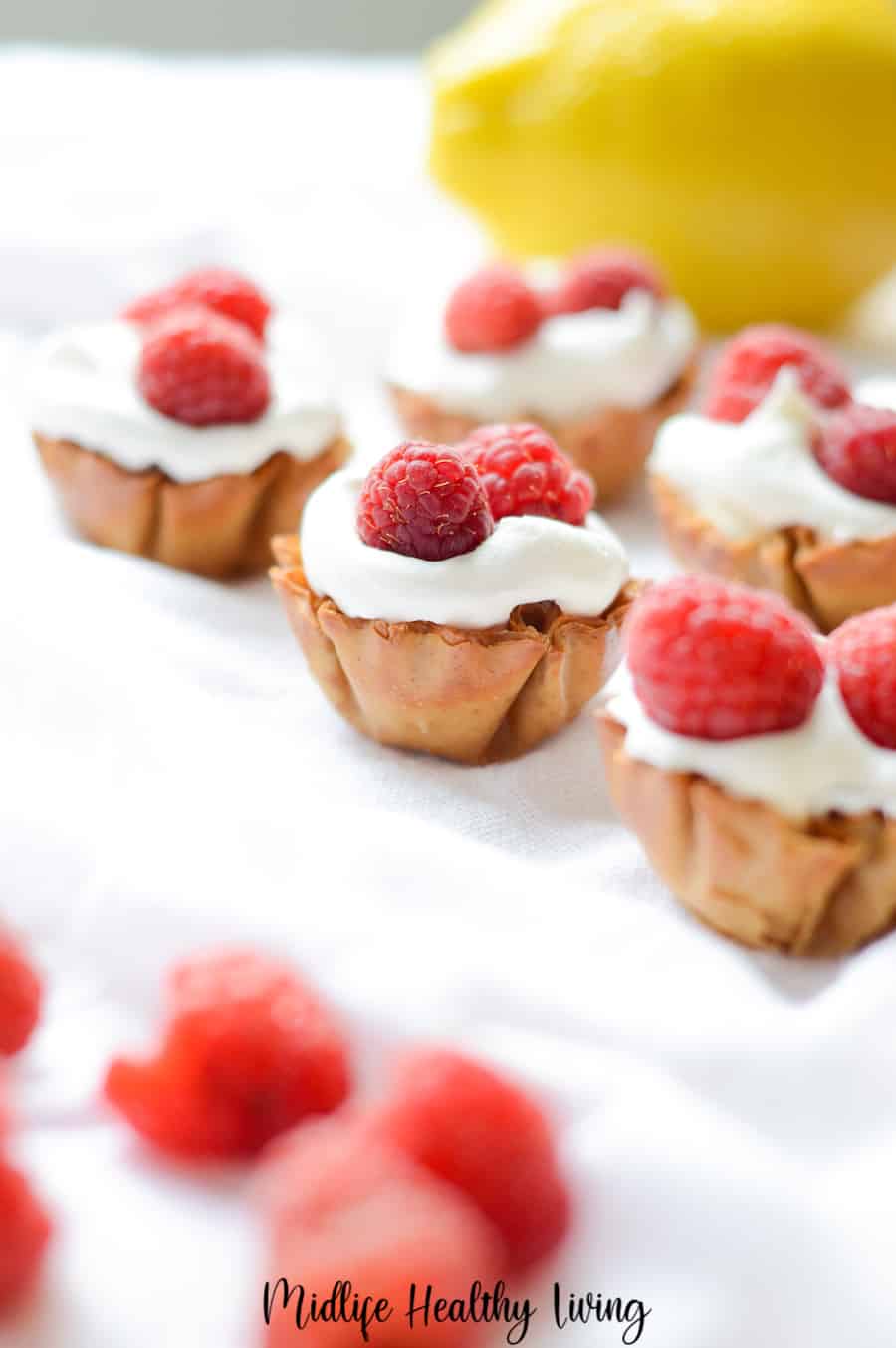 A vertical image showing the finished no bake cheesecake cups. 