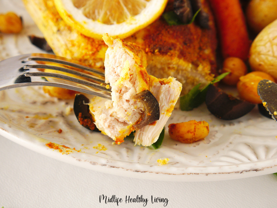 A bite of chicken sheet pan dinner on a fork. 