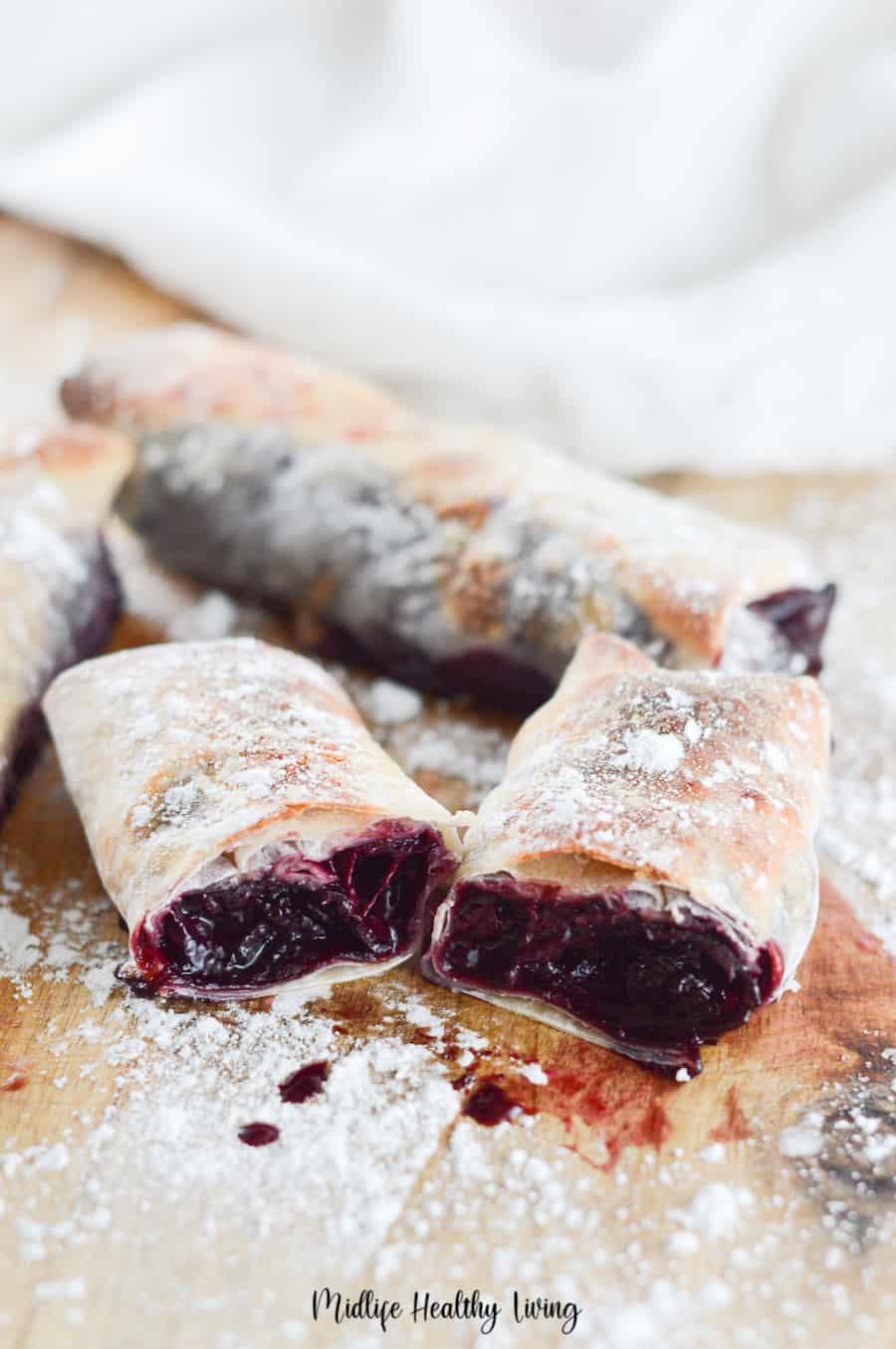 An image of the finished fresh cherry pie filling inside an egg roll wrapper made in the air fryer. 