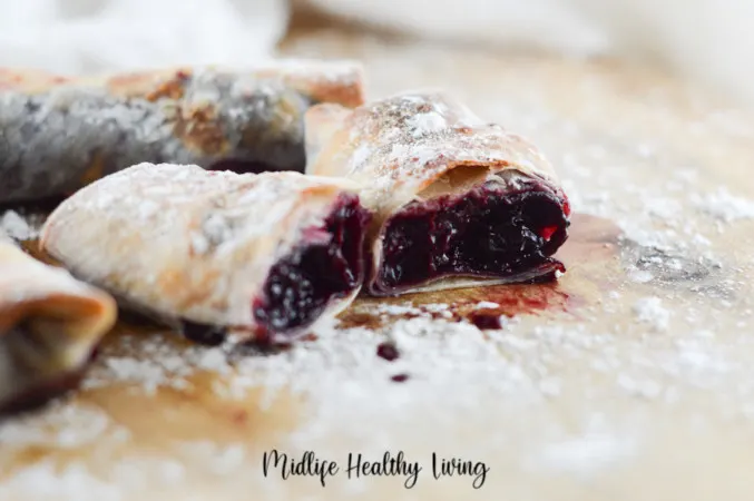 A horizontal image showing the finished weight watchers cherry pies cut in half so you can see the insides. 