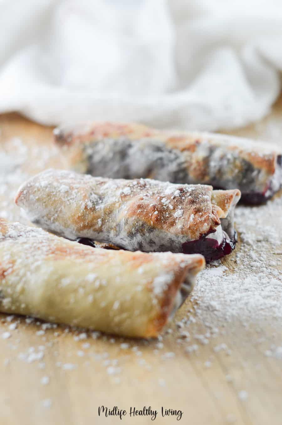 This is a look at the egg rolls wrapped up and fried in the air fryer filled with cherry pie filing ready to be eaten. 