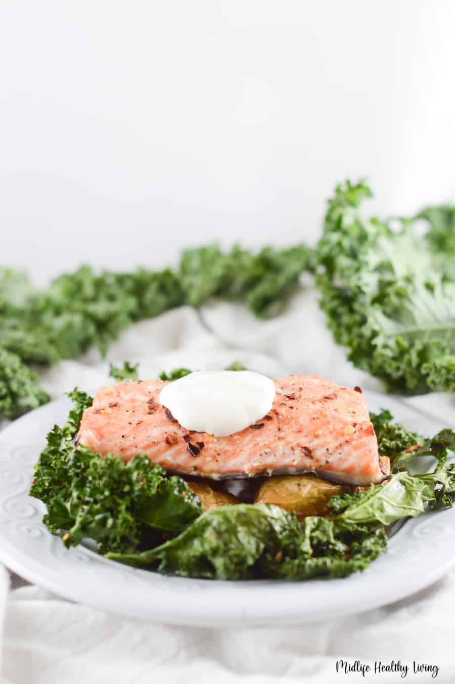 This is a delicious Weight Watchers salmon sheet pan meal that you can make in less than an hour! It also features a creamy but tangy yogurt sauce which balances everything out and make this the perfect weeknight dinner! 