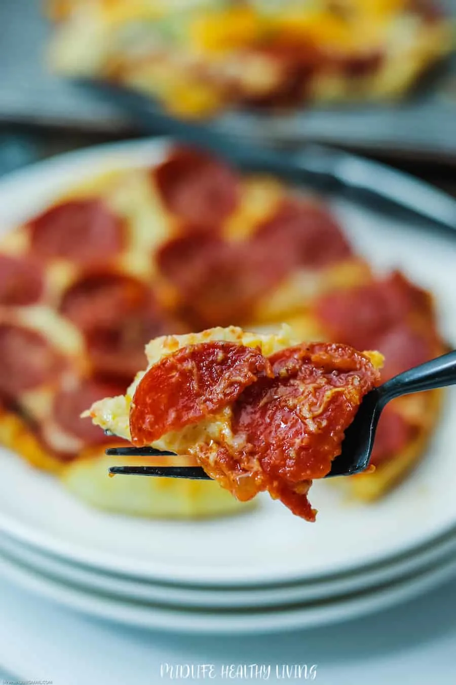 Here we see a bite of ww pizza recipe on a fork ready to be devoured. 