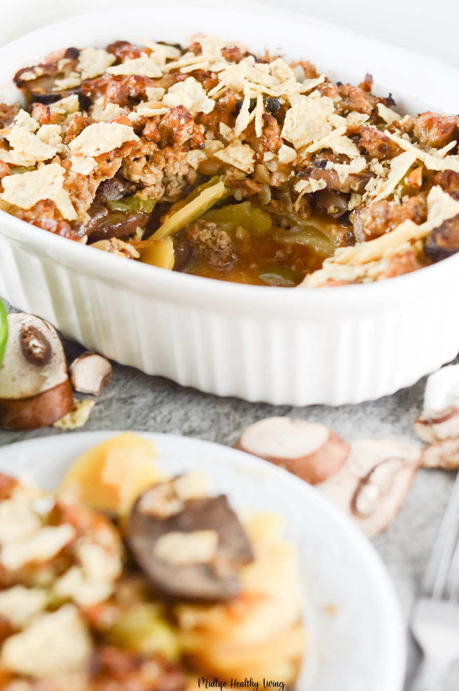 Here we see the casserole pan with a serving out of it and a plate with the serving ready to be enjoyed. 