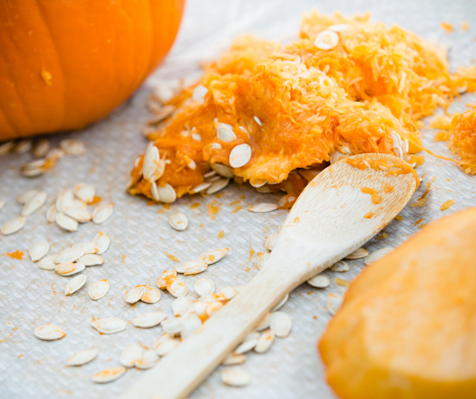 guts being scooped out of a pumpkin