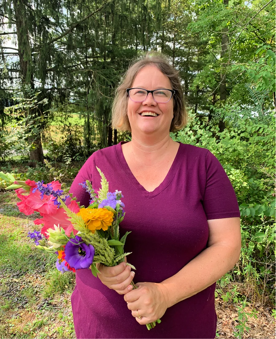 Caucasion middle age female holding a bouquet of flowers.