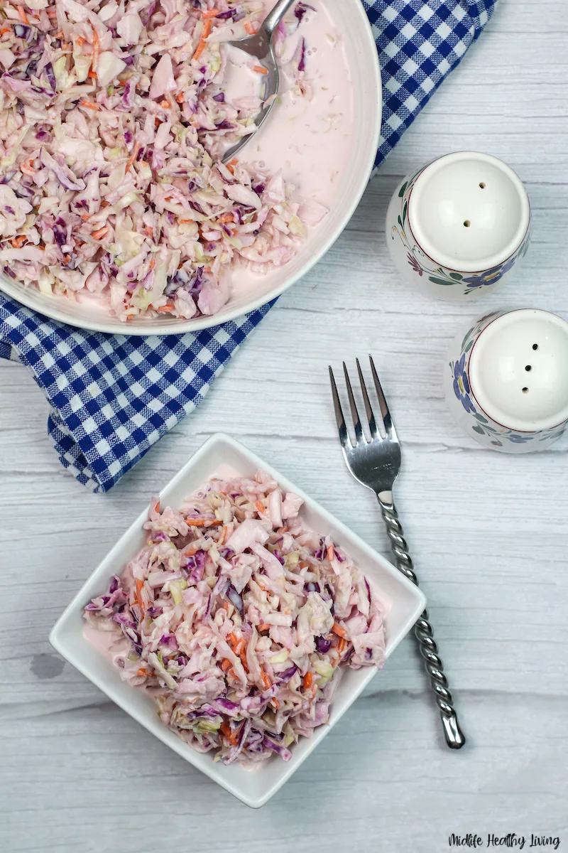 A top down look at a bowl full of the finished coleslaw ready to serve and eat. 