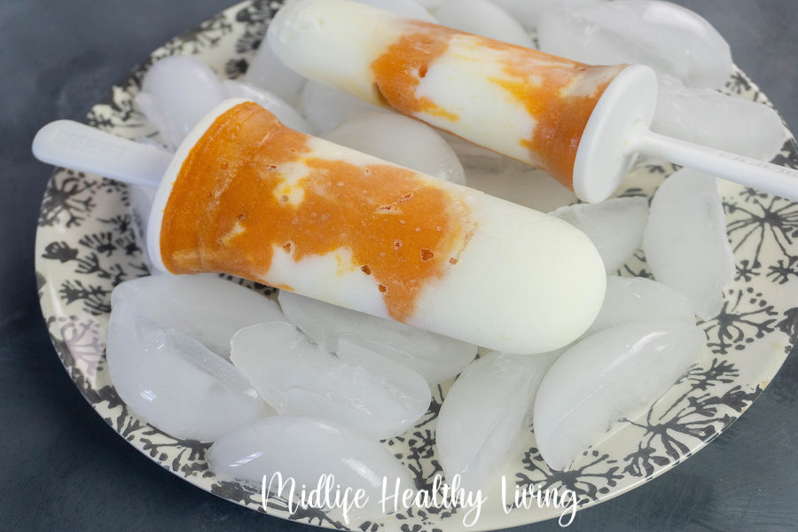 A close up view of the finished weight watchers frozen yogurt popsicles with pumpkin. 