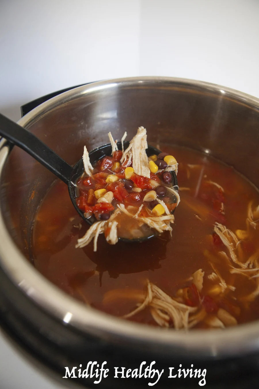 A scoop of the finished Weight Watchers chicken chili ready to be served and eaten. 