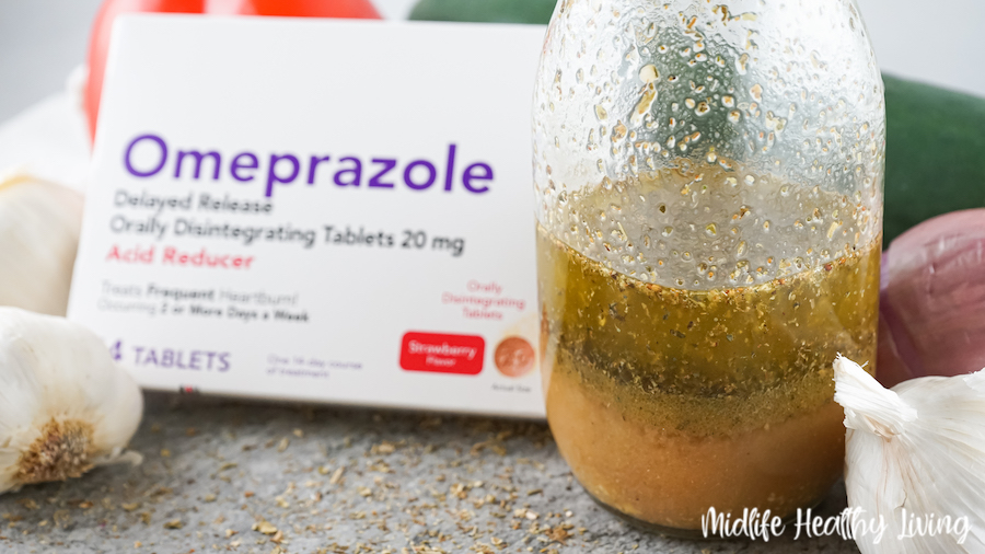 Salad dressing finished in a jar with the omeprazole tablets in the box beside. 