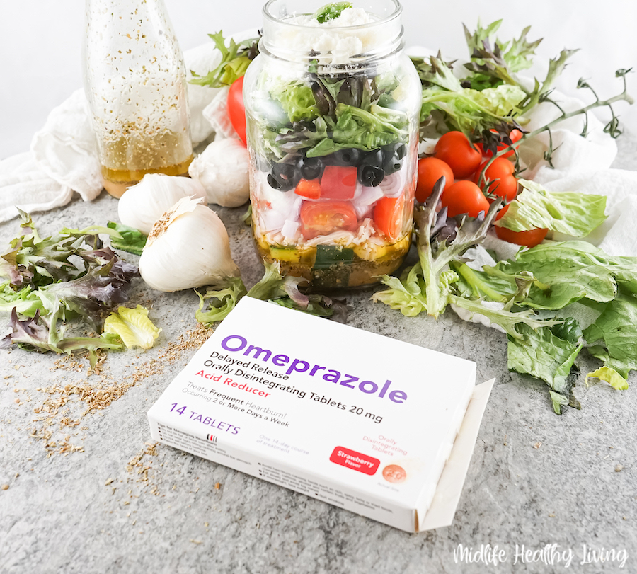 Another look at the box of omeprazole tablets in front of the salad ready to eat. 