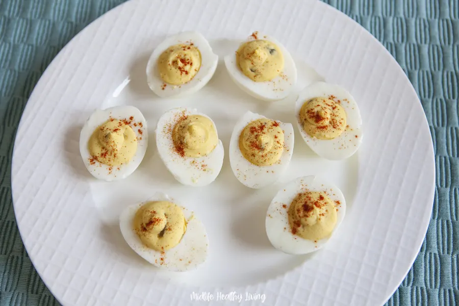 A plate full of the finished deviled eggs ready to share. 