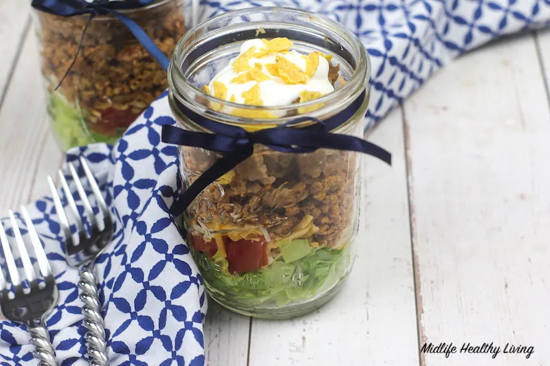 a horizontal image of the finished jar salad ready to eat