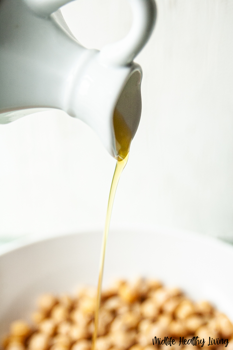 oil being added to the chickpeas. 