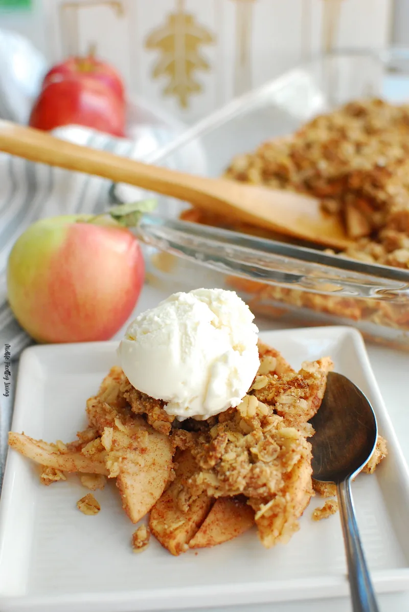 A close up of the finished apple crisp with ice cream ready to eat. 