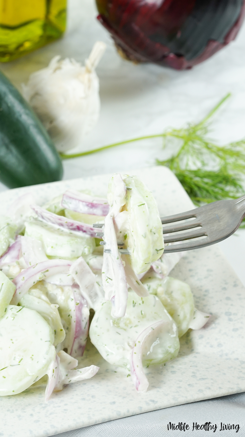 A bite of the finished weight watchers cucumber salad on a fork ready to eat. 