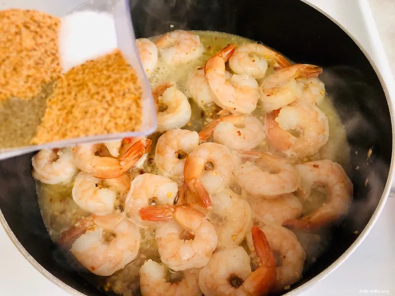 more seasoning being added to the plan of cooking shrimp. 