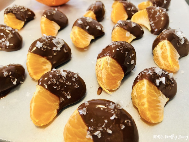 oranges dipped and ready to chill to harden the chocolate 