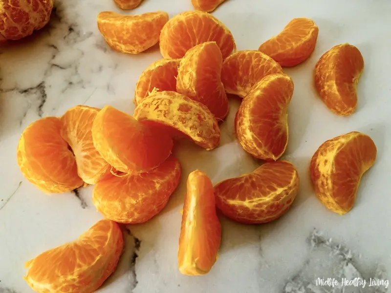 peeled oranges ready to dip in chocolate 