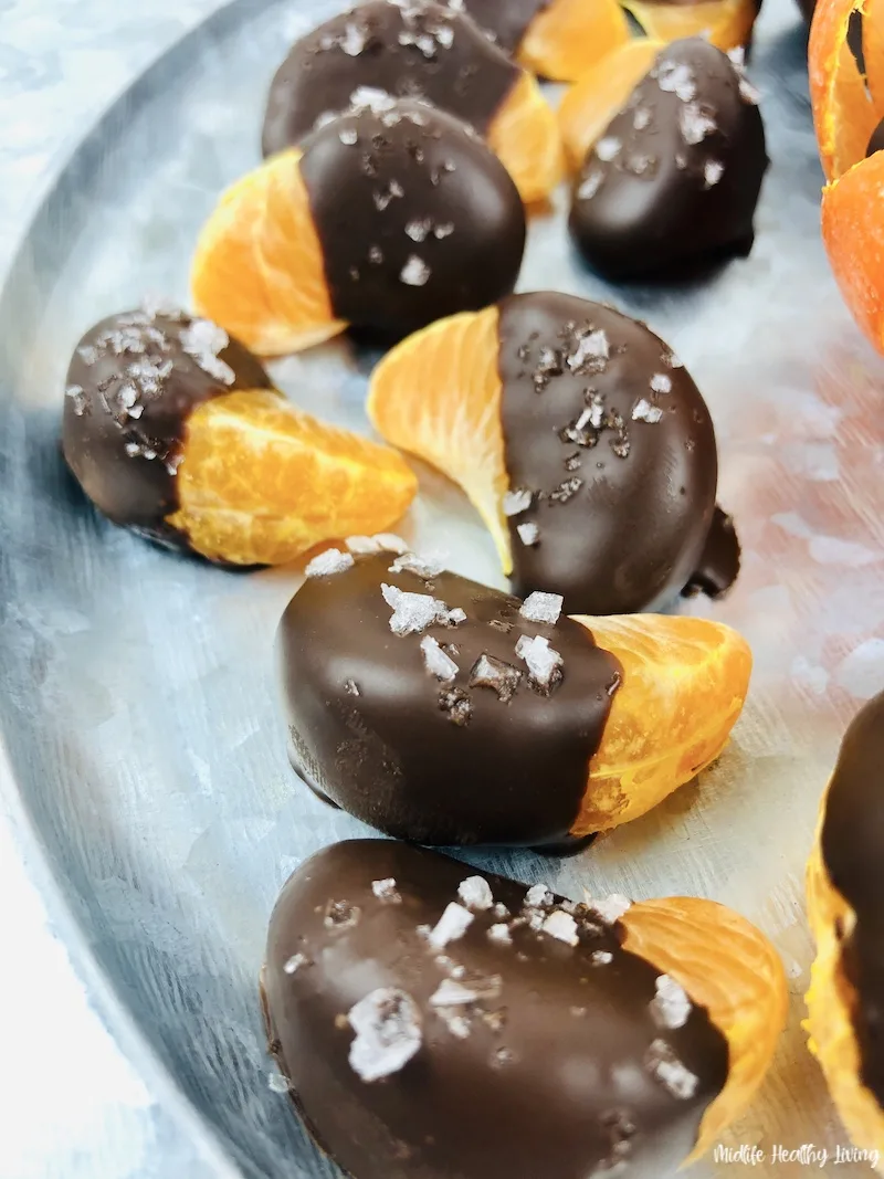 some of the finished chocolate covered oranges laid out on a tray ready to serve