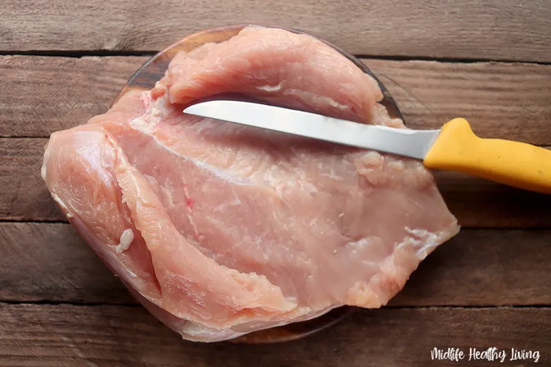 cutting turkey breast so it's ready to pound out.