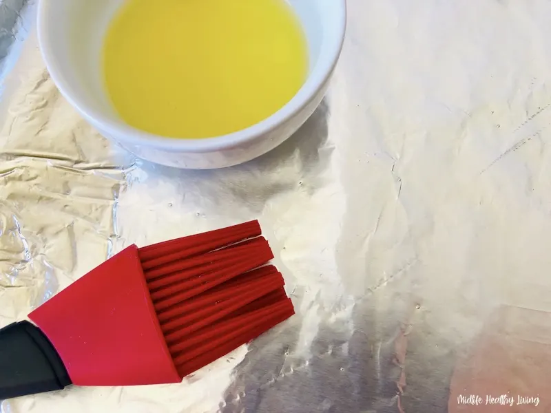 oil being put onto the sheet.