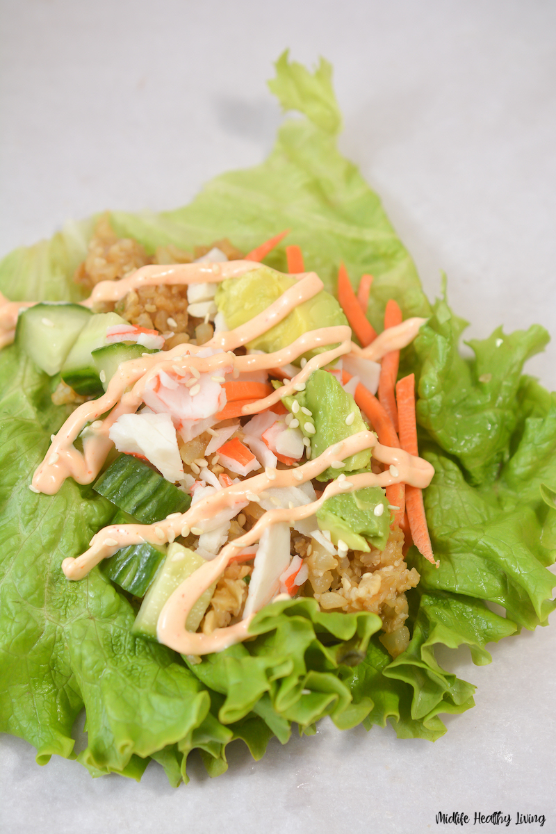 garnish being added to the California roll salad. 