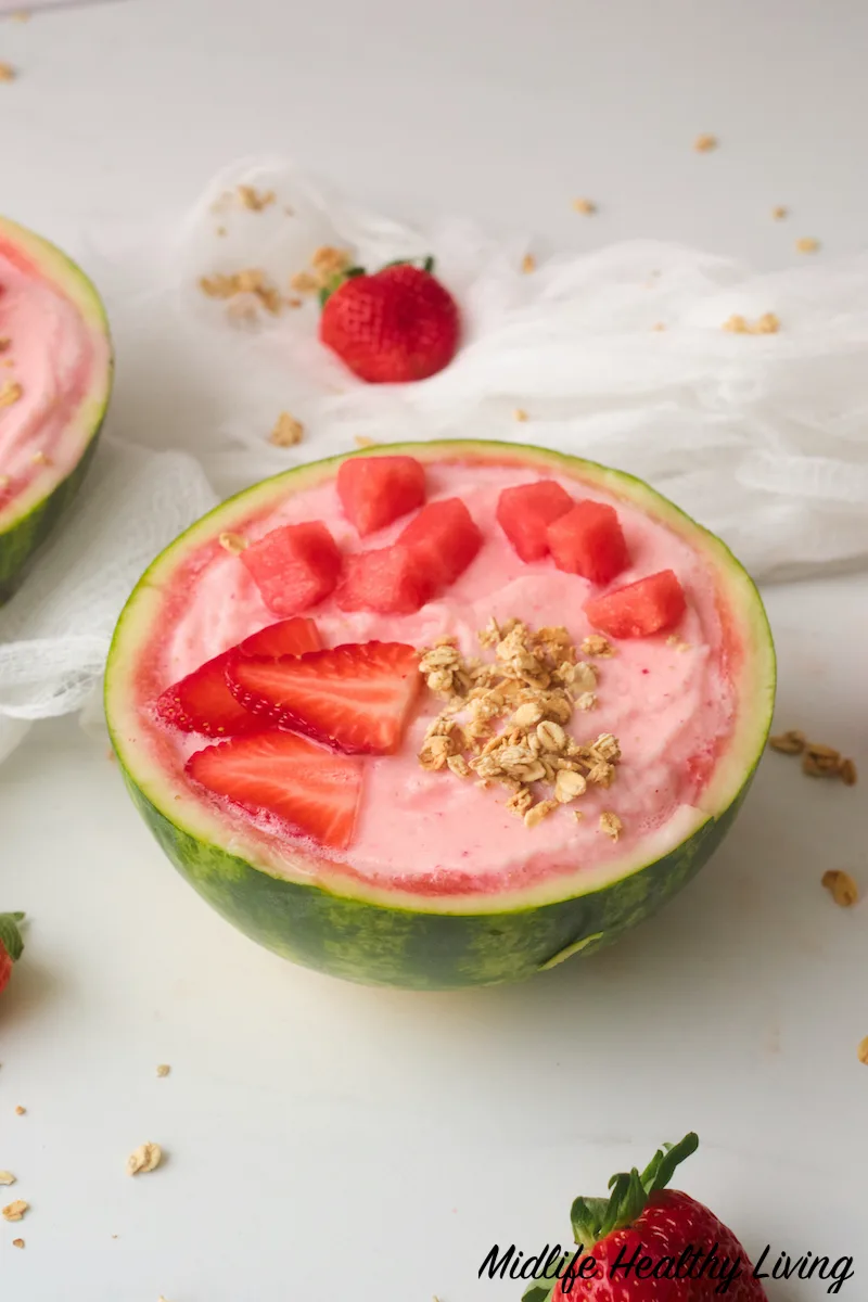side view of toppings added to watermelon smoothie bowl