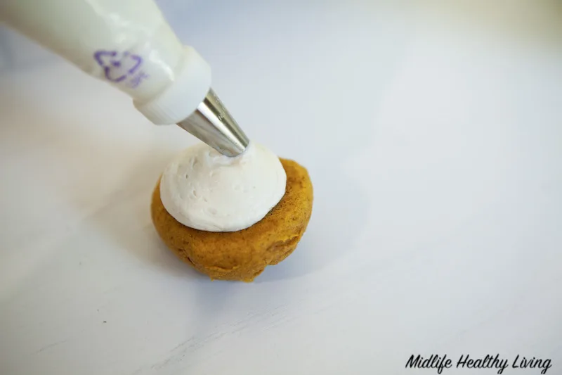 using icing bag to fill the whoopie pies